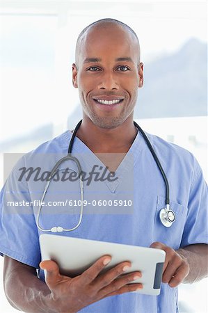 Male doctor with tablet computer