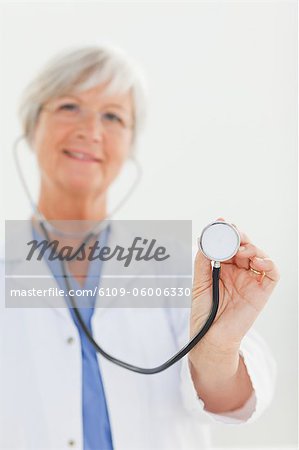 Stethoscope being used by mature doctor