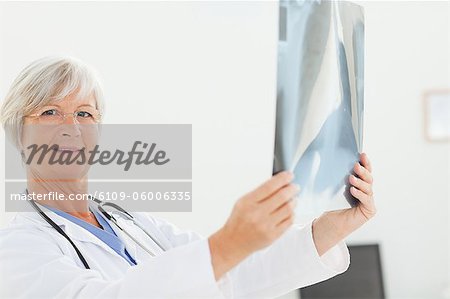 Side view of mature doctor holding an x-ray