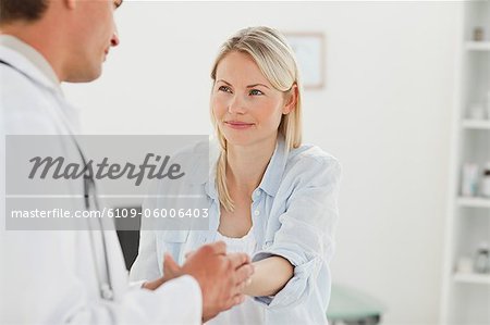 Male doctor examining his female patient