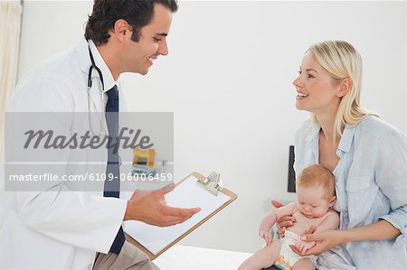 Doctor talking with mother about her little baby