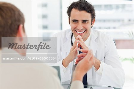 Man talking with his young doctor