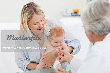 Woman with her little baby visiting the doctor