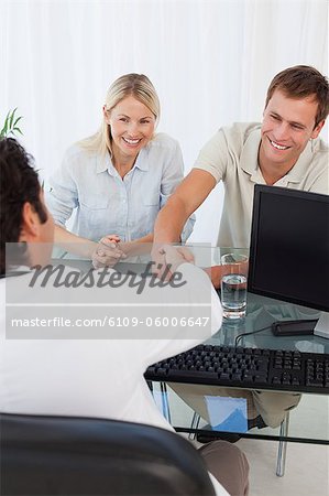 Smiling couple visiting the doctor together