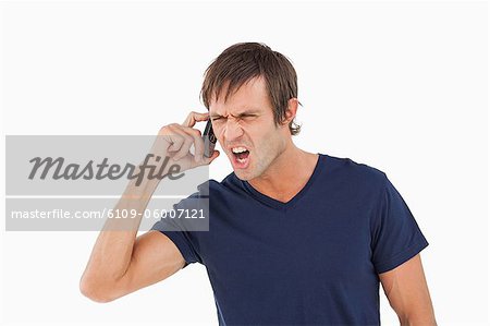 Furious man shouting while calling with his mobile phone