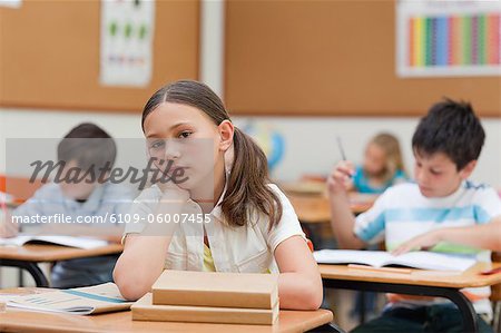 Sad looking little girl in class