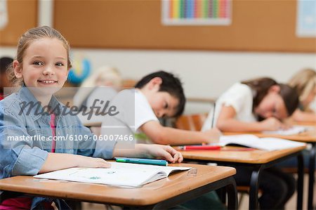 Side view of young schoolgirl during class