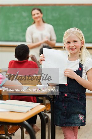 Smiling little girl showing her test results