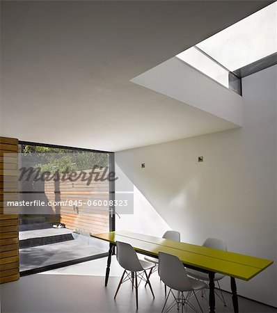 Dining table below skylight in Islington house extension. Architects: Paul Archer Design