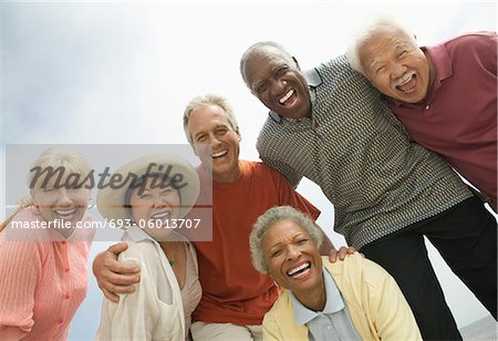 Group of friends laughing, outdoors, (low angle view)