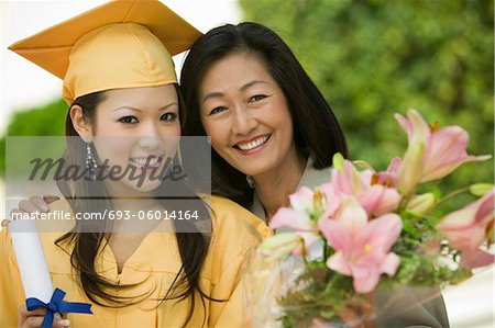 Graduate and mother outside, portrait