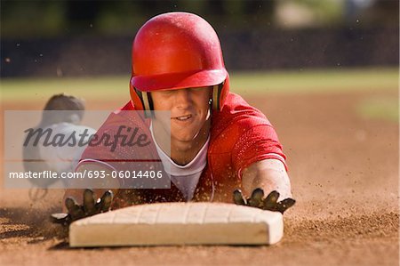 Baseball player sliding into base