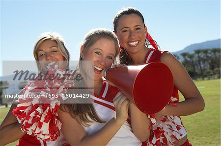 Cheerleaders Holding Megaphone on field, portrait, (portrait)