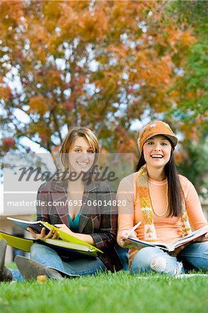 Two students studying outdoors, (portrait)