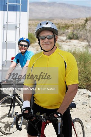 Couple preparing for bicycle ride, portrait