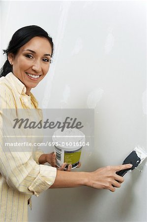 Woman speckling interior wall