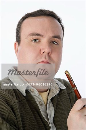 Portrait of mid-adult man holding pen