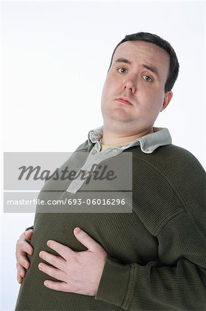 Overweight mid-adult man with hands on his belly