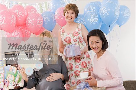 Women Holding Gifts at a Baby Shower