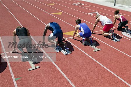 Male sprinters in starting blocks