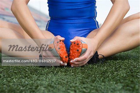 Female athlete stretching, close-up view