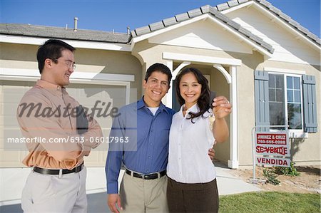 Young couple buying house, holding keys