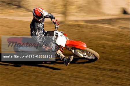 Motocross racer on dirt track