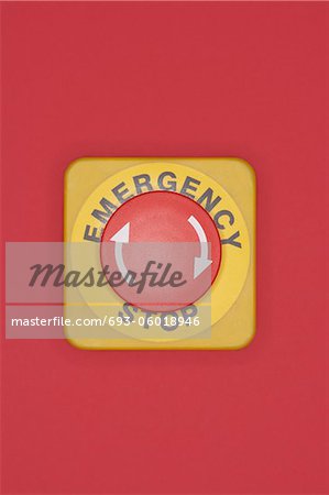 Emergency stop button on red background