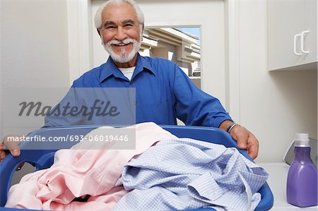 Elderly man with laundry basket