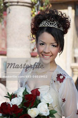 Girl (13-15) with bouquet at Quinceanera, portrait