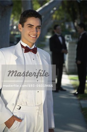 Portrait of boy (13-15) in tuxedo at Quinceanera