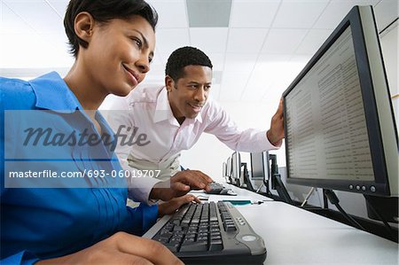 Man and woman using computer together