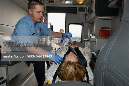 Paramedic taking care of victim in ambulance