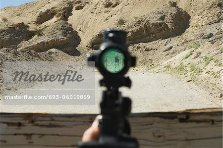 Rifle sight aiming at target on firing range