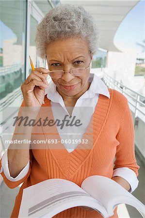 Woman holding book at school, portrait