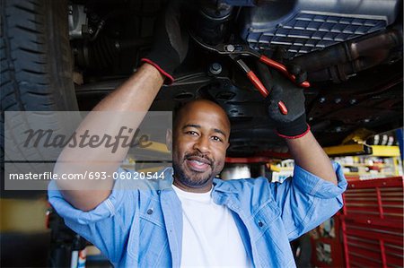 Auto Mechanic Beneath a Car