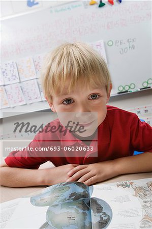 Schoolboy Reading a Geography Book