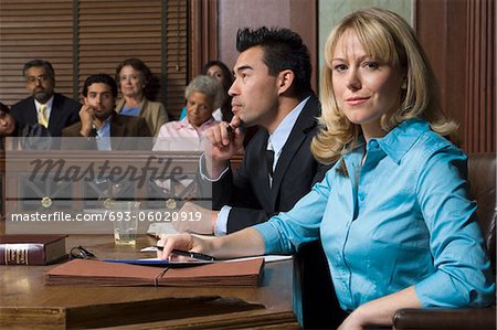 Defense lawyer with client in court