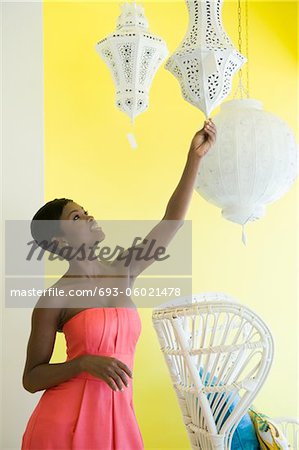 Shopper reaches for white painted metal lampshade