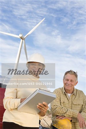 Couple working at wind farm