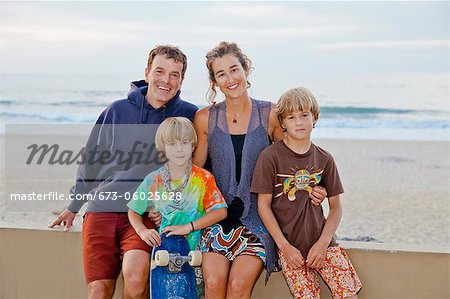 Man and woman with two boys on beach boardwalk