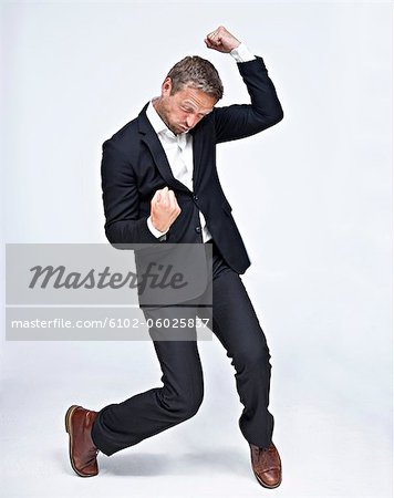 Businessman dancing and punching air