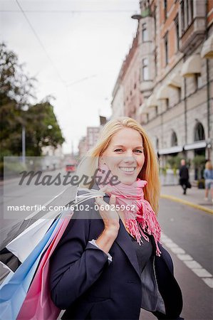 Portrait of woman with shopping bags in street