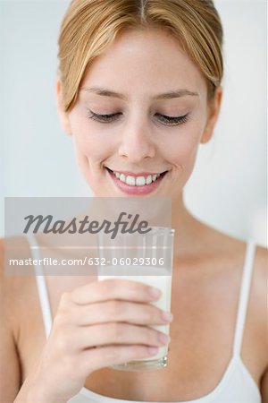 Young woman holding glass of milk