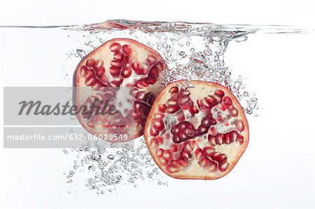 Pomegranate halves submerged in water