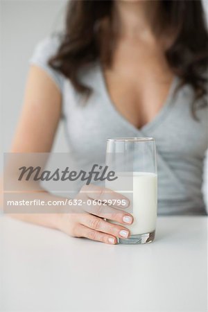 Woman holding glass of milk