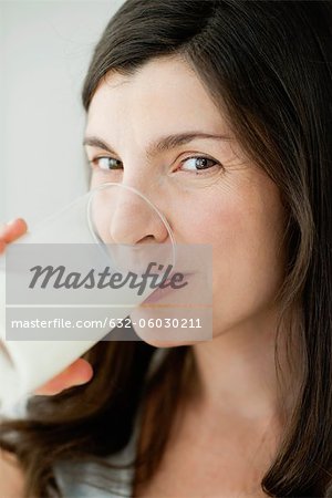 Mid-adult woman drinking glass of milk