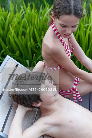 Brother and sister relaxing on deckchair