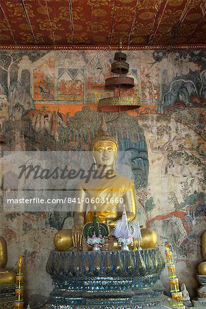 Seated Buddha statue with murals in the background, Wat Pak Huak, Luang Prabang, Laos, Indochina, Southeast Asia, Asia
