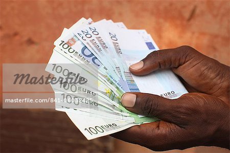 African holding Euros, Lome, Togo, West Africa, Africa